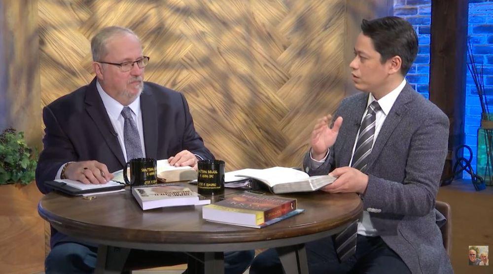Pastor Steve Cioccolanti on The Coming Apocalypse with Paul Begley at a talk-show table with Bibles